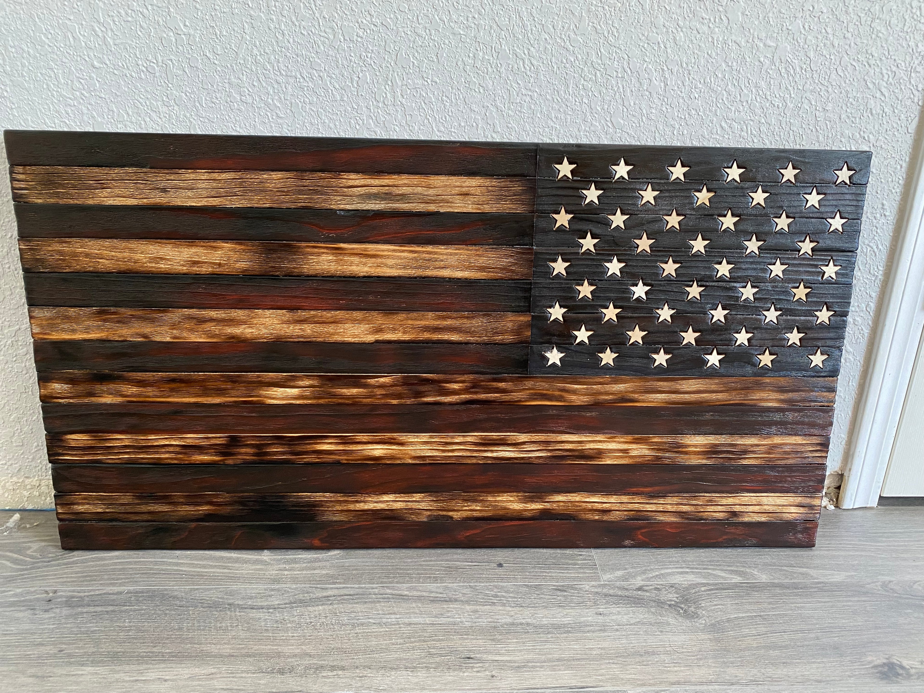 Add a touch of patriotism to your home decor with our custom wooden distressed American flag. Handcrafted from high-quality wood, each flag features a unique distressed finish for a rustic and vintage look. Customize your flag with personalized engravings such as names, dates, or meaningful quotes, making it a one-of-a-kind piece. Perfect for displaying indoors or outdoors, this flag is a timeless symbol of pride and heritage. Shop now and elevate your space with our custom wooden distressed American flag.