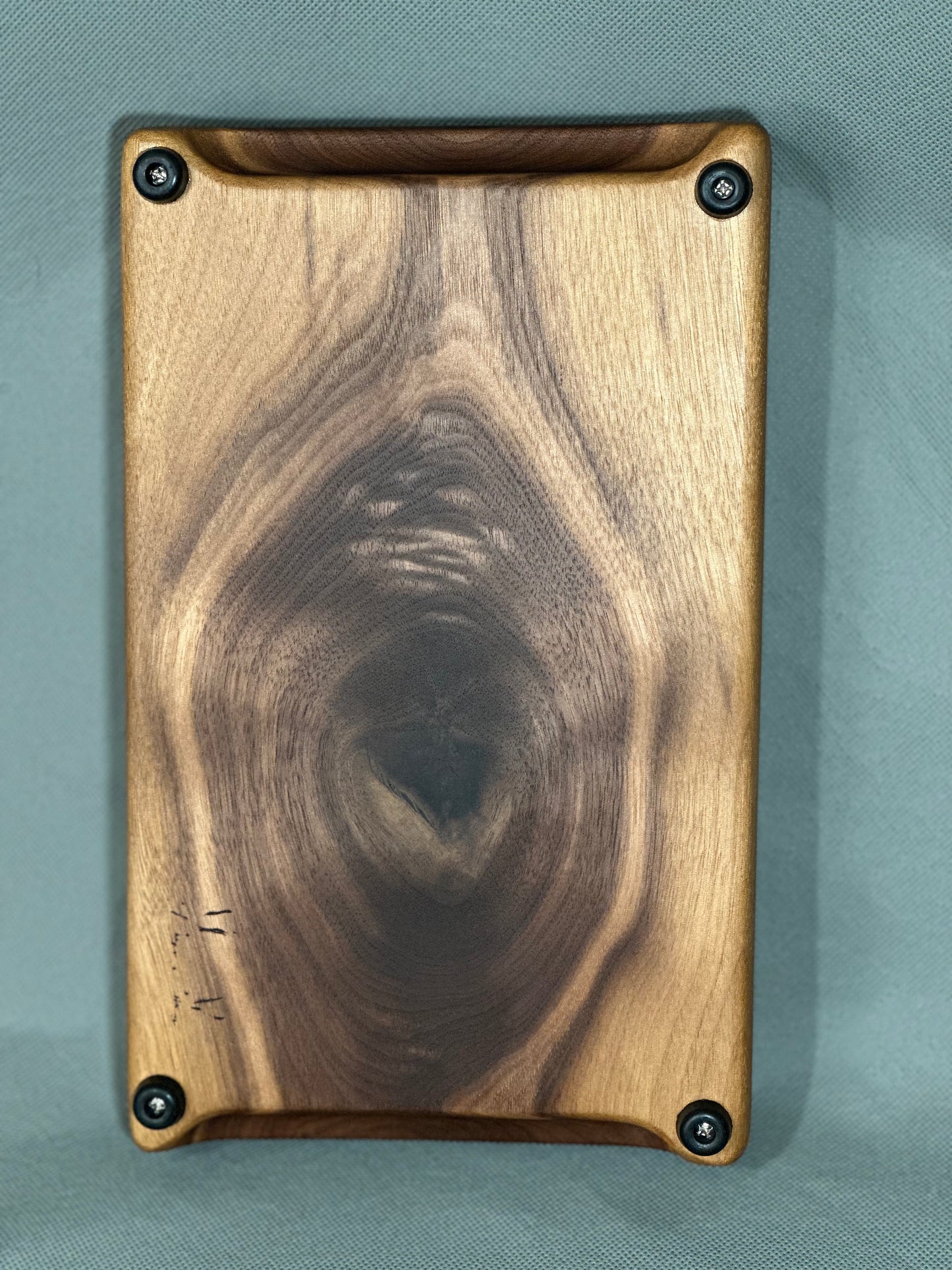 The Knot showcases the natural aesthetic of walnut in this serving board. Whether you're indulging in a cheese plate, showcasing snacks at a social gathering, or safeguarding your surface from heat damage—this board makes an elegant show piece or a perfect gift!