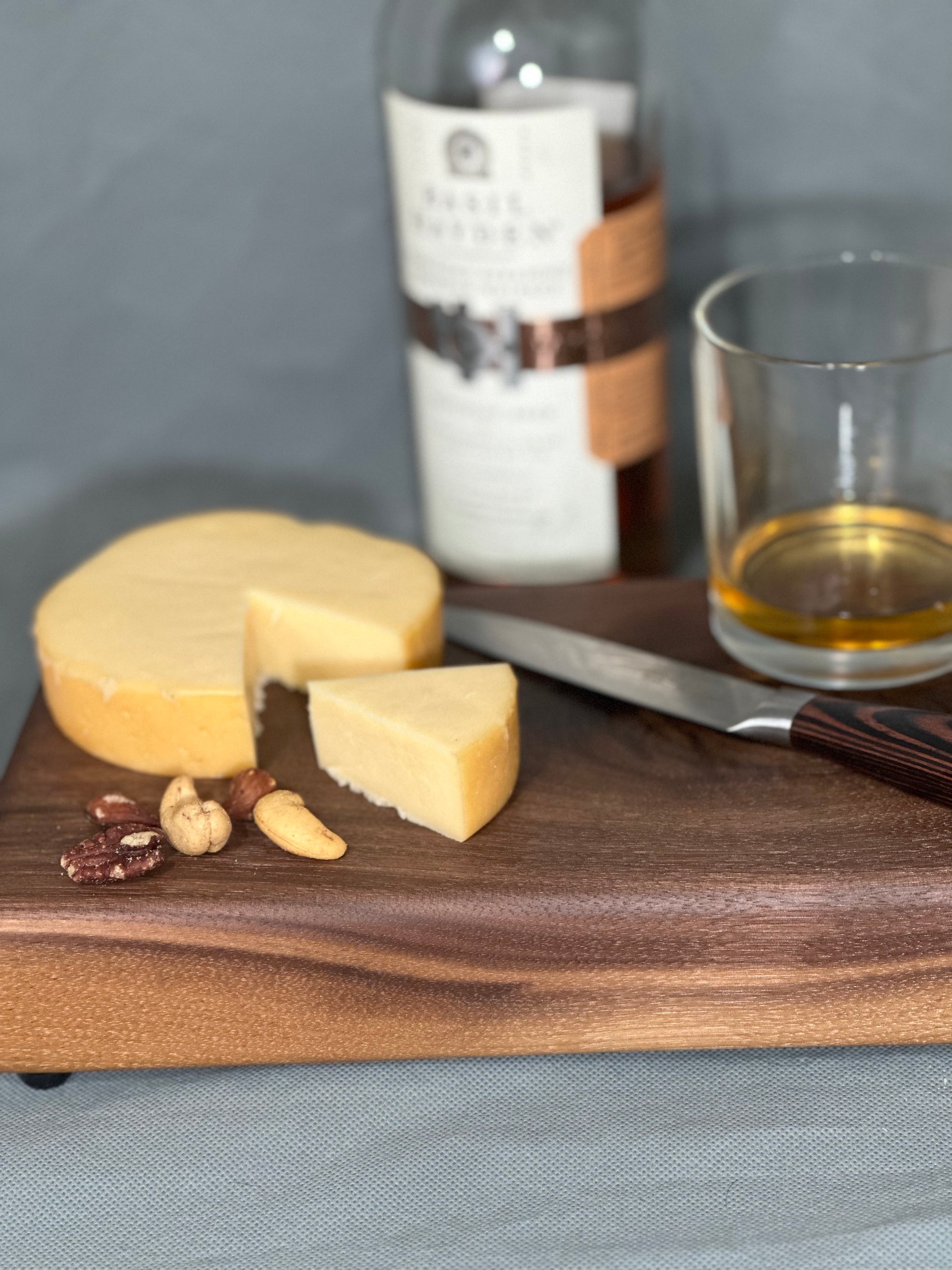 The Knot showcases the natural aesthetic of walnut in this serving board. Whether you're indulging in a cheese plate, showcasing snacks at a social gathering, or safeguarding your surface from heat damage—this board makes an elegant show piece or a perfect gift!