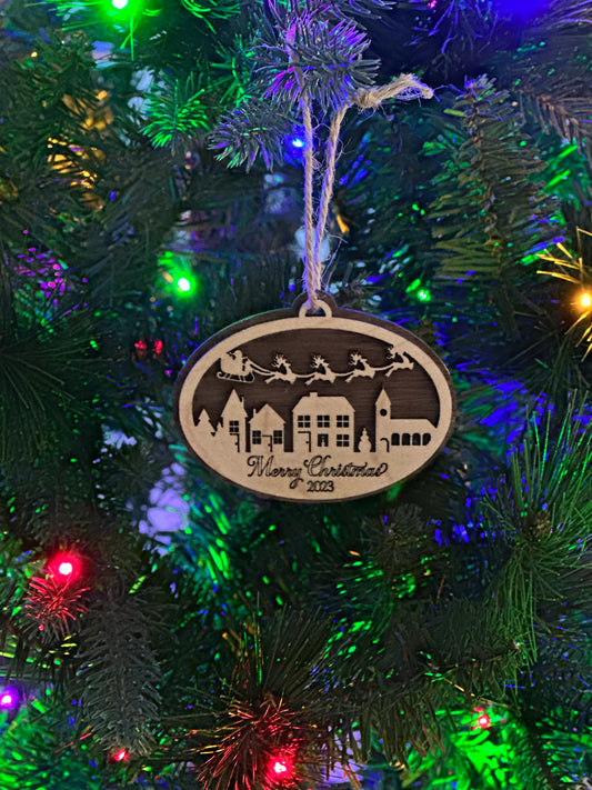 Mark your 2023 Christmas with this chic wooden trinket -- Santa and his sleigh soaring over a village below -- "Merry Christmas 2023" engraved on the bottom. This ornament make a perfect gift or a great way to commemorate your 2023 Christmas.