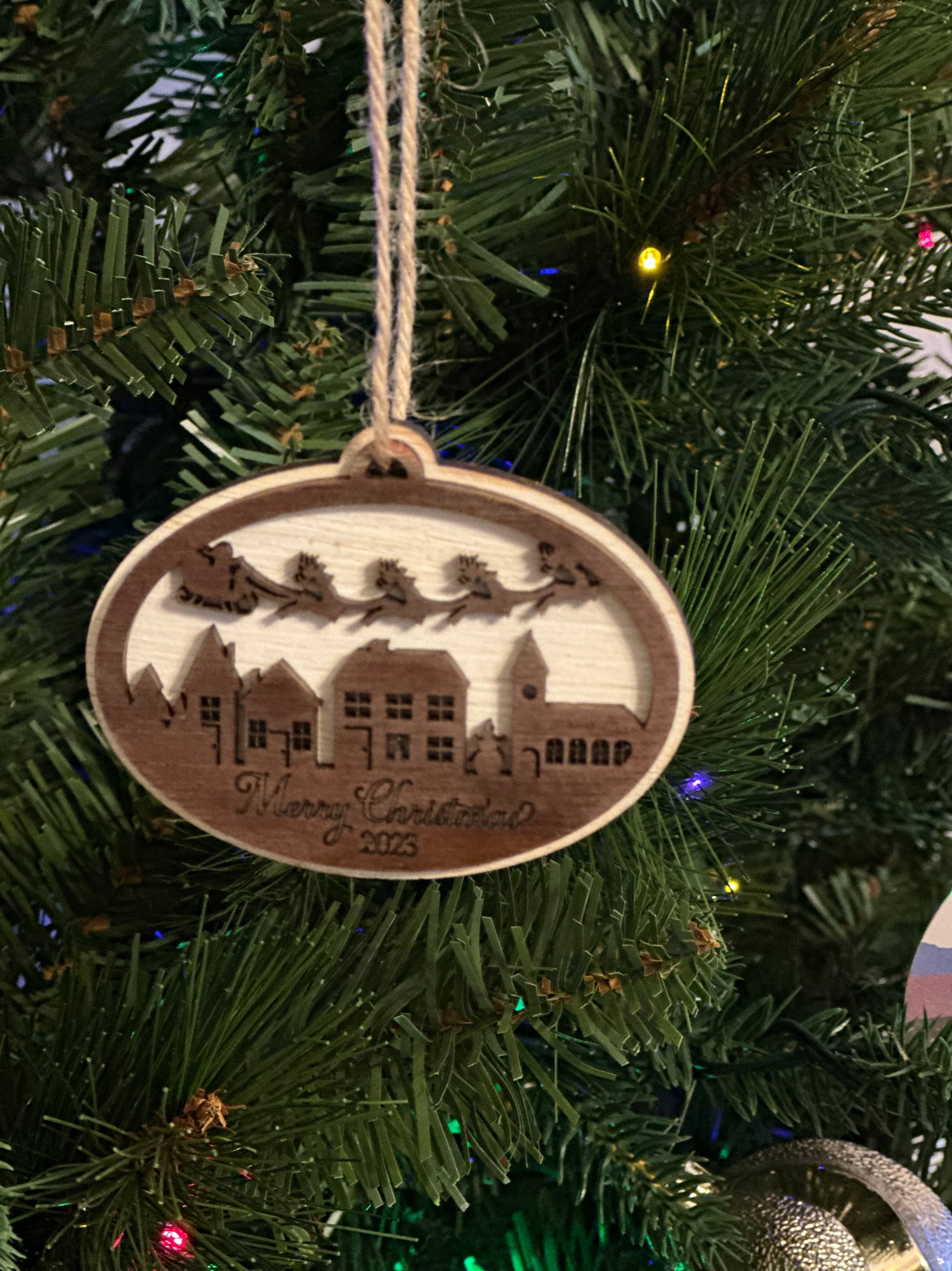 Mark your 2023 Christmas with this chic wooden trinket -- Santa and his sleigh soaring over a village below -- "Merry Christmas 2023" engraved on the bottom. This ornament make a perfect gift or a great way to commemorate your 2023 Christmas.