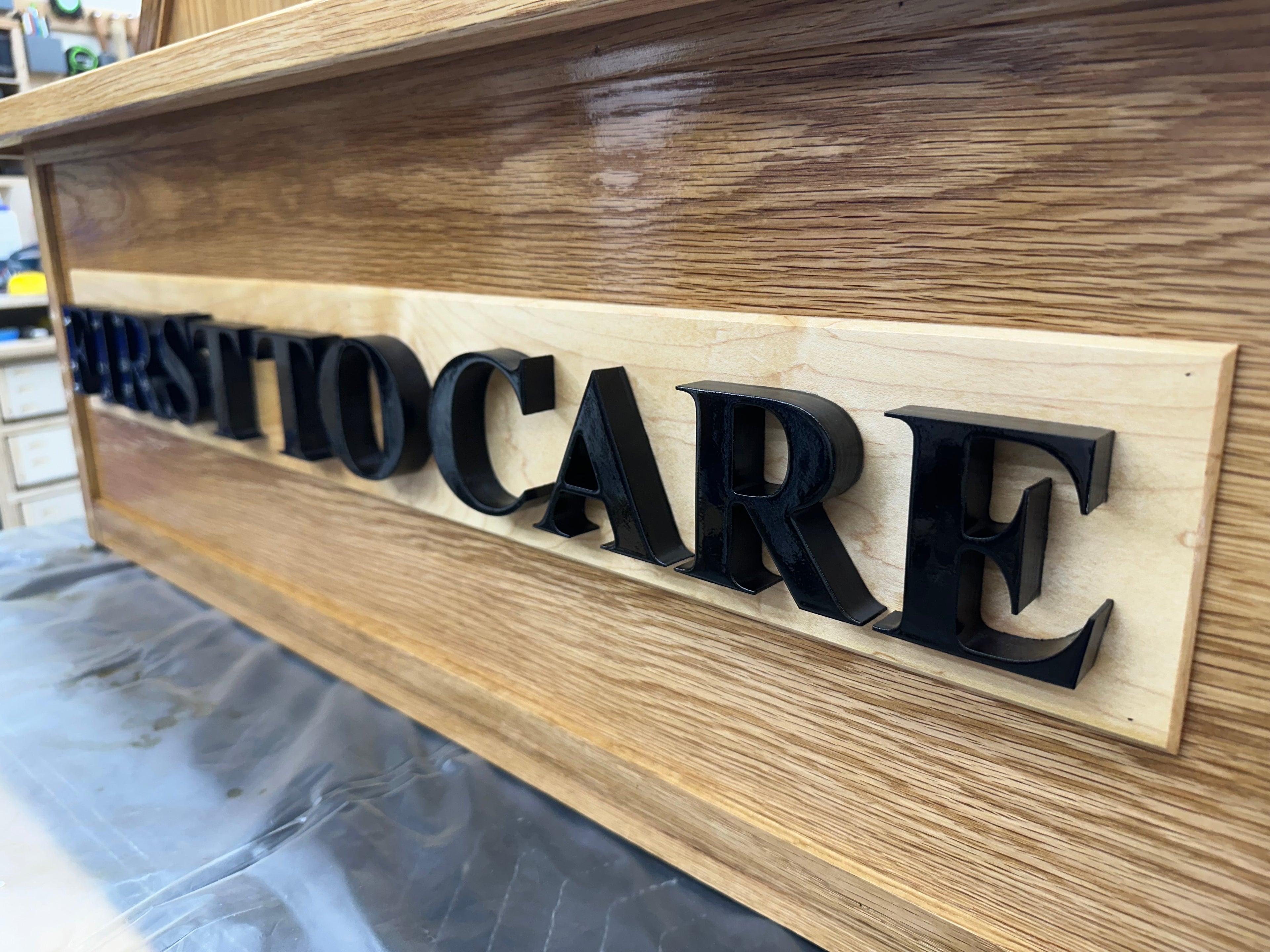 3D Lettering painted black with WBAMC motto, "First To Care." 