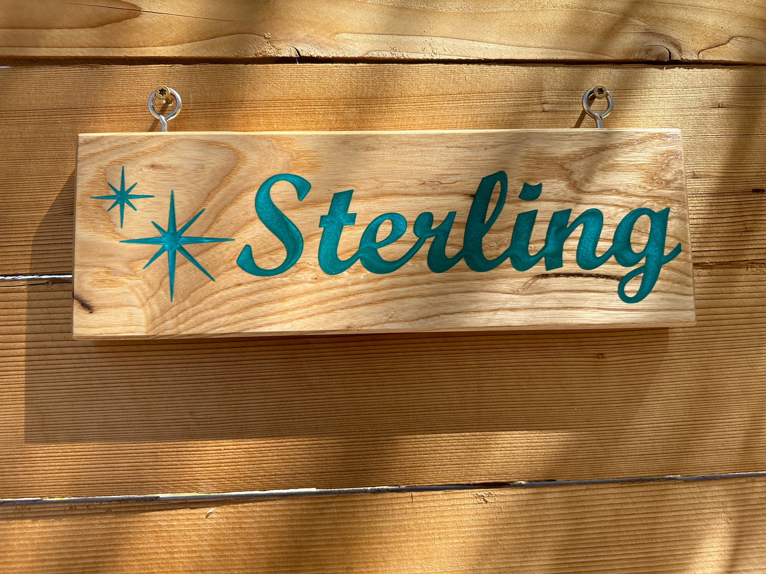 Custom Horse Stall Sign with Teal Epoxy inlay. The teal contrasts with the white ash nicely. These are 100% customizable. This sign called for a custom star burst pattern. 